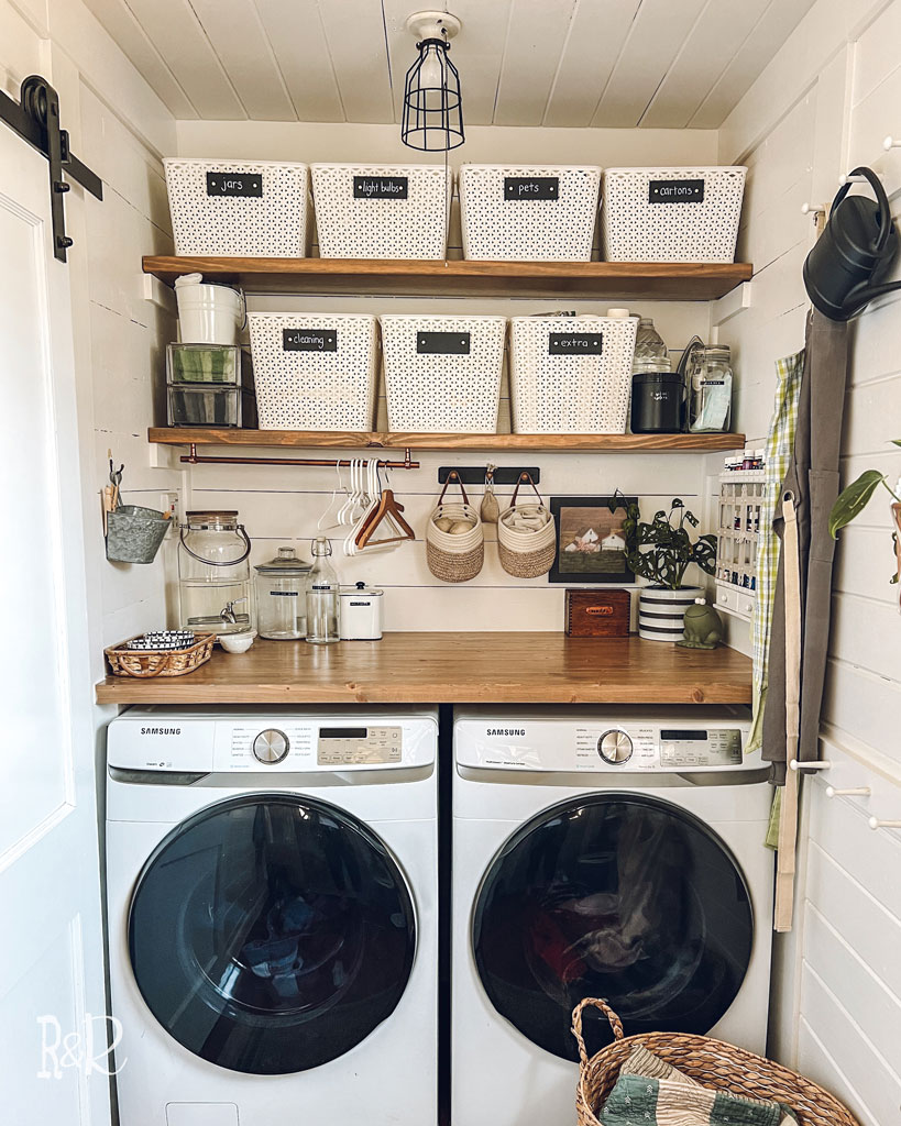 neatly organized wood shelves above wood laundry counter over washer and dryer 