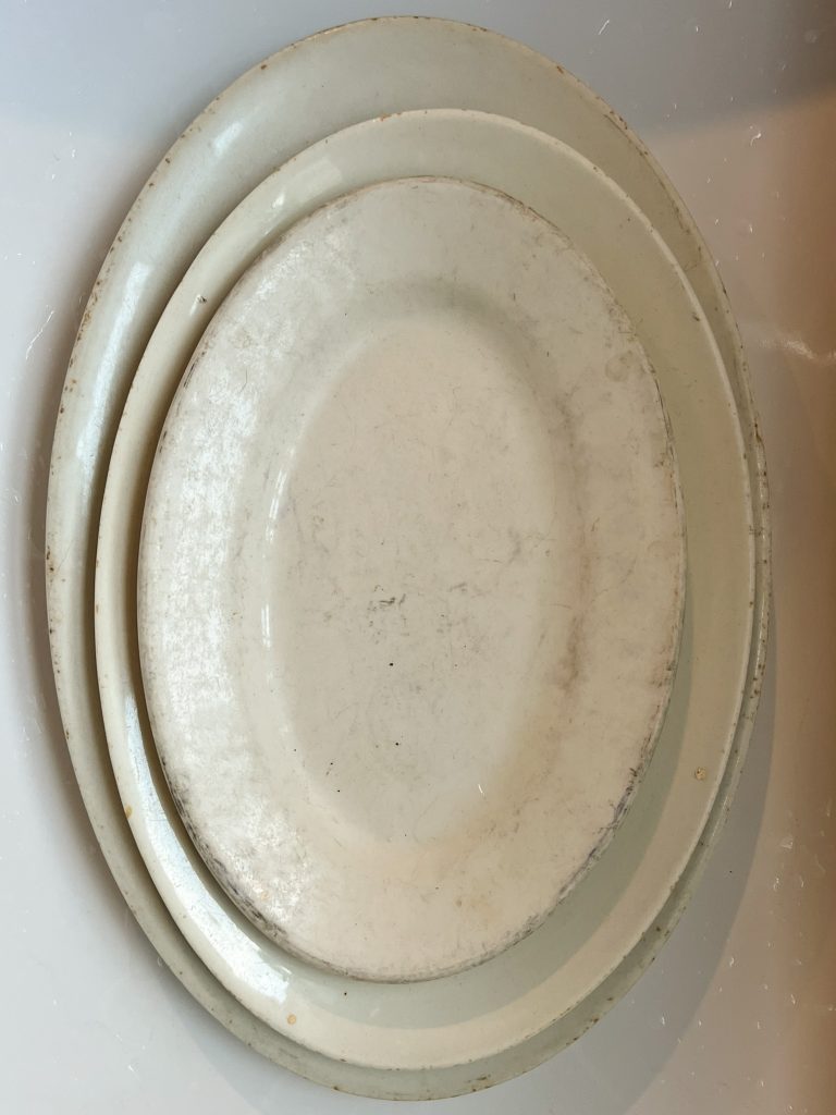 dingy white thrifted platter with gray marks